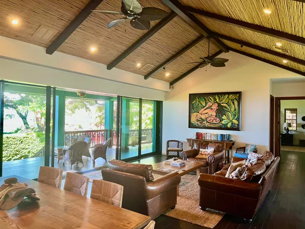 a media room with lots of windows and furniture