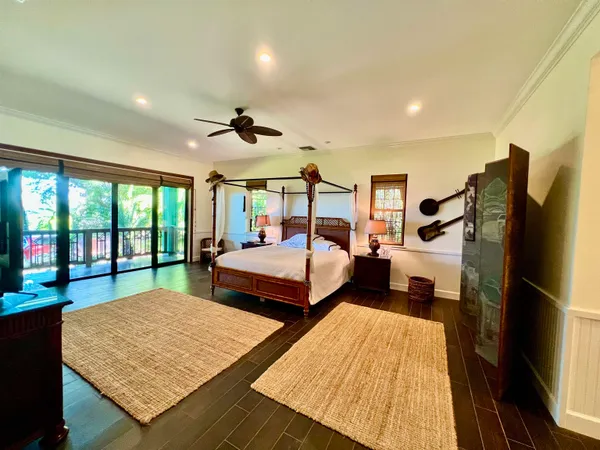 a bedroom with double bed and a large window