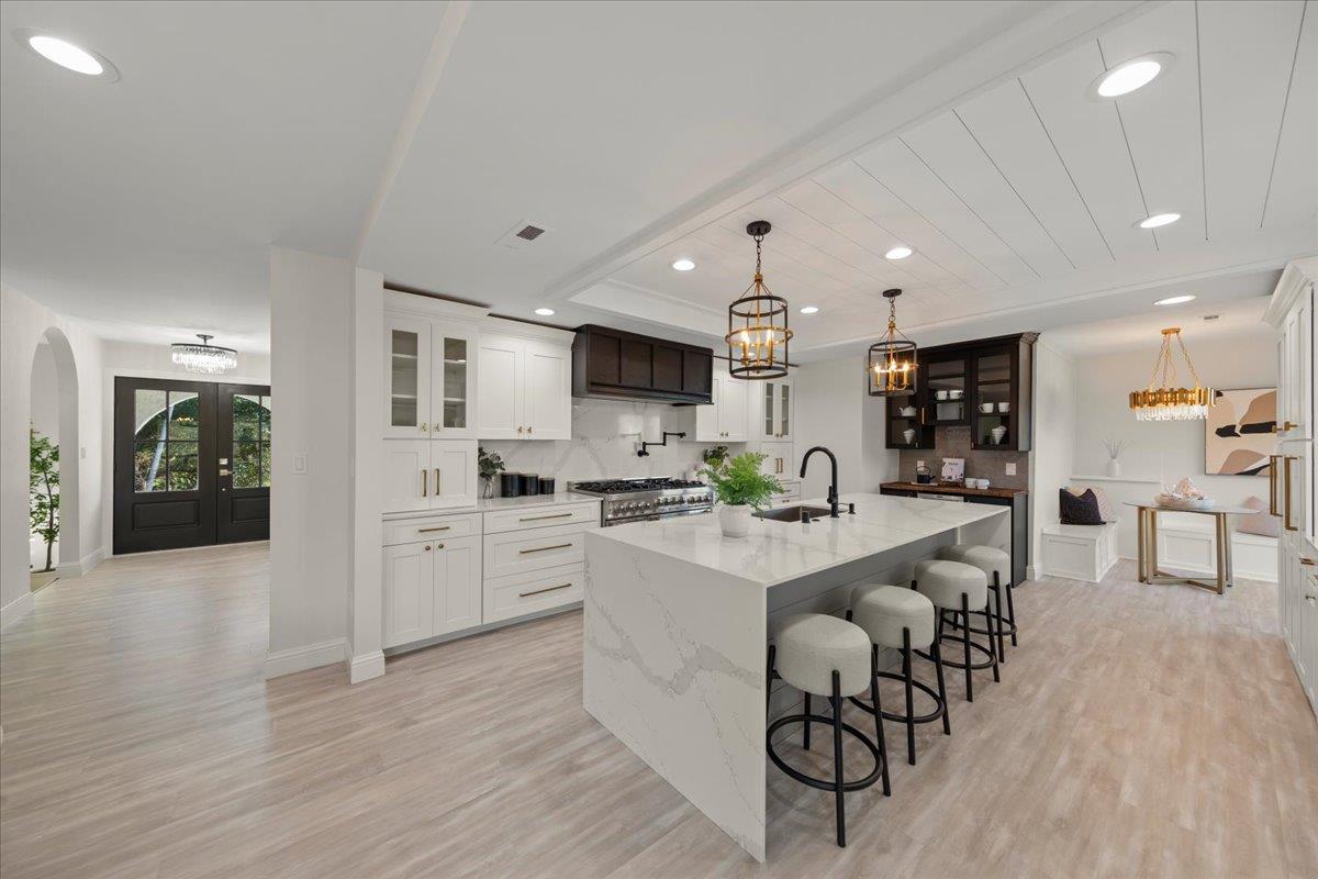 2915 Thomas Grde Morgan Hill, CA 95037 - Photo 13 of 87 a large white kitchen with lots of counter space and stainless steel appliances