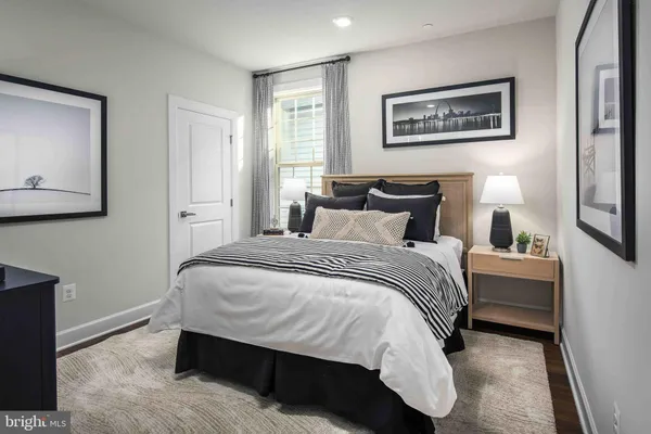 a bedroom with bed and paintings on the wall