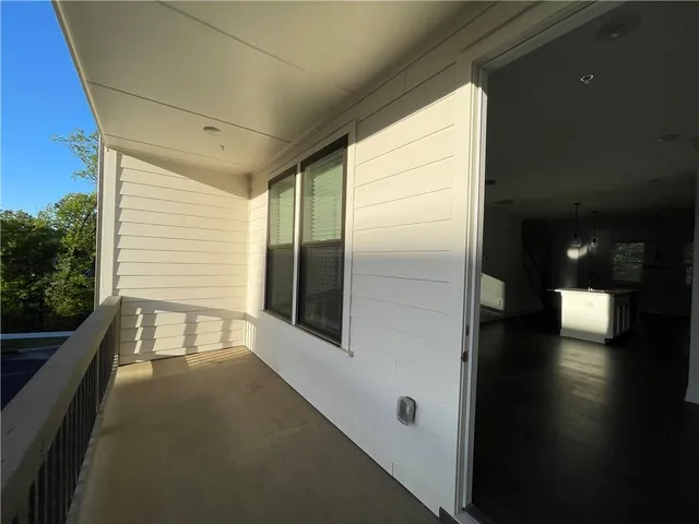 a kitchen with kitchen island a counter top space a sink stainless steel appliances and cabinets