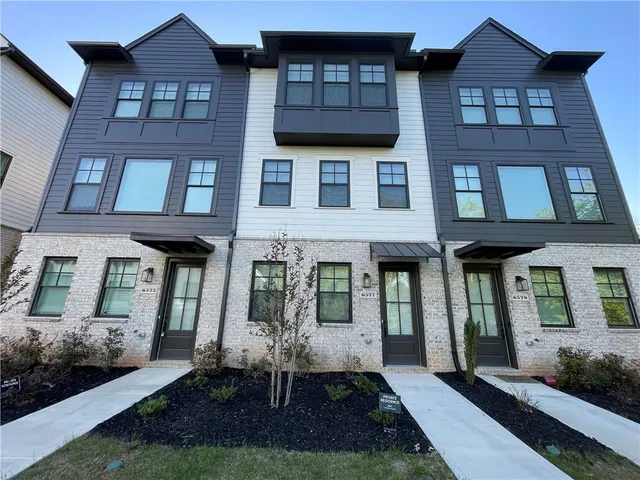 a view of kitchen with granite countertop cabinets stove and a sink