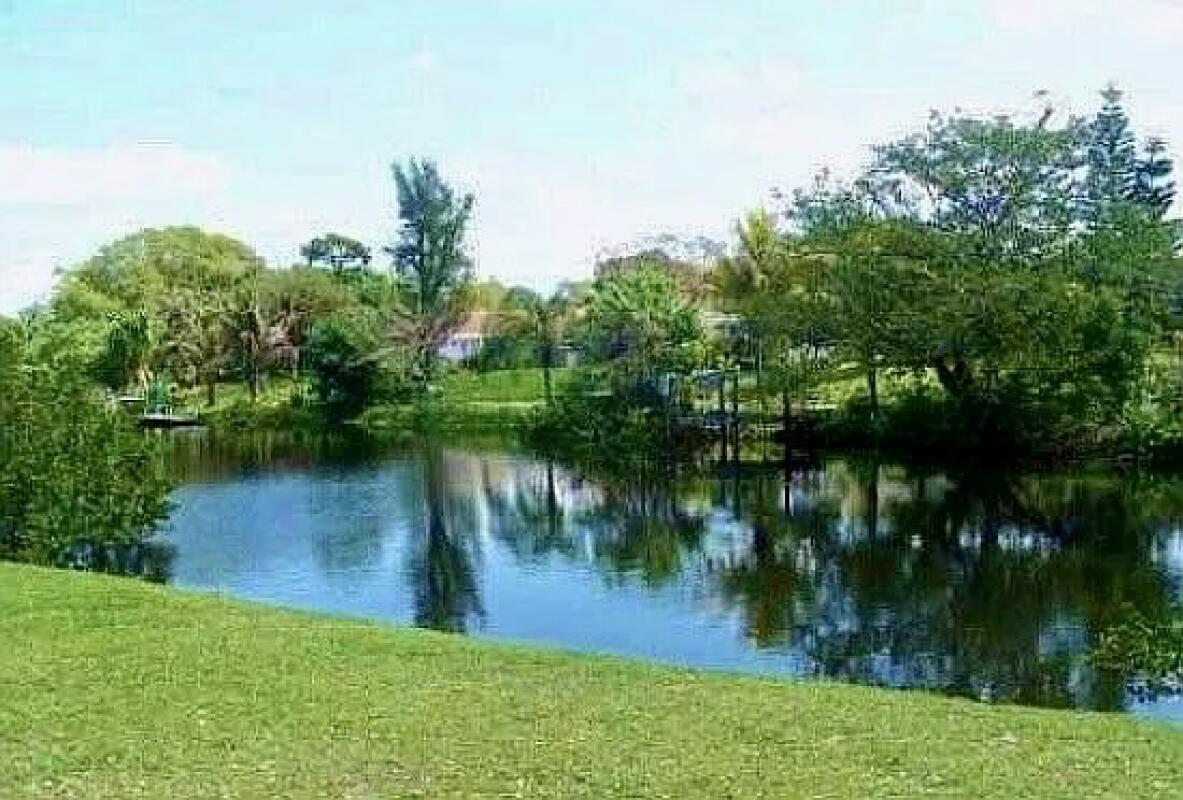 610 Northwest 13th Street, Unit 23 Boca Raton, FL 33486 - Photo 28 of 28 a view of a lake with a house in the background
