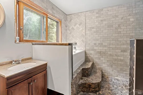 a bathroom with a sink a toilet and a shower curtain
