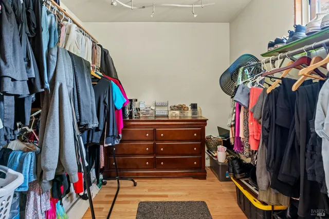 a view of walk in closet with clothes