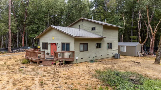 a view of house with yard and sitting area