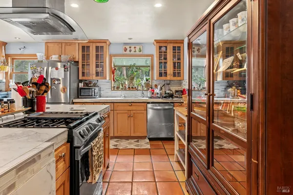 a kitchen that has a lot of windows in it