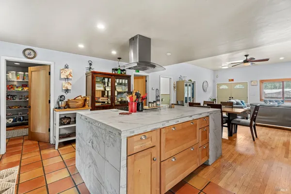 a kitchen with stainless steel appliances kitchen island granite countertop a sink and cabinets