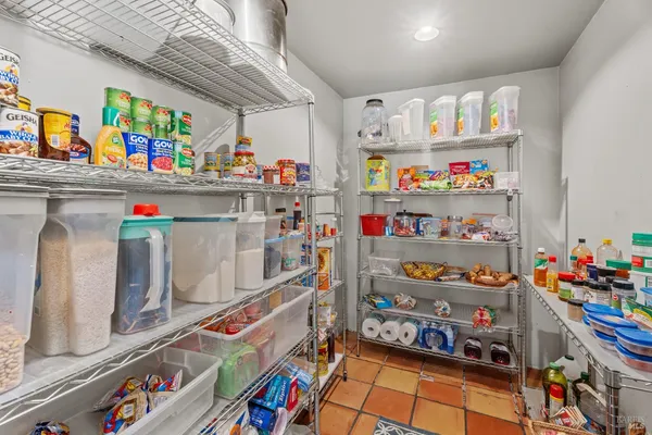 a store room with lots of clutter and furniture