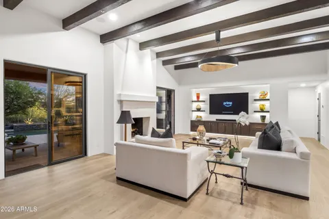 a living room with furniture a fireplace and a large window