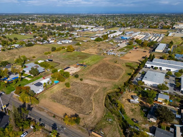 an aerial view of residential houses with outdoor space