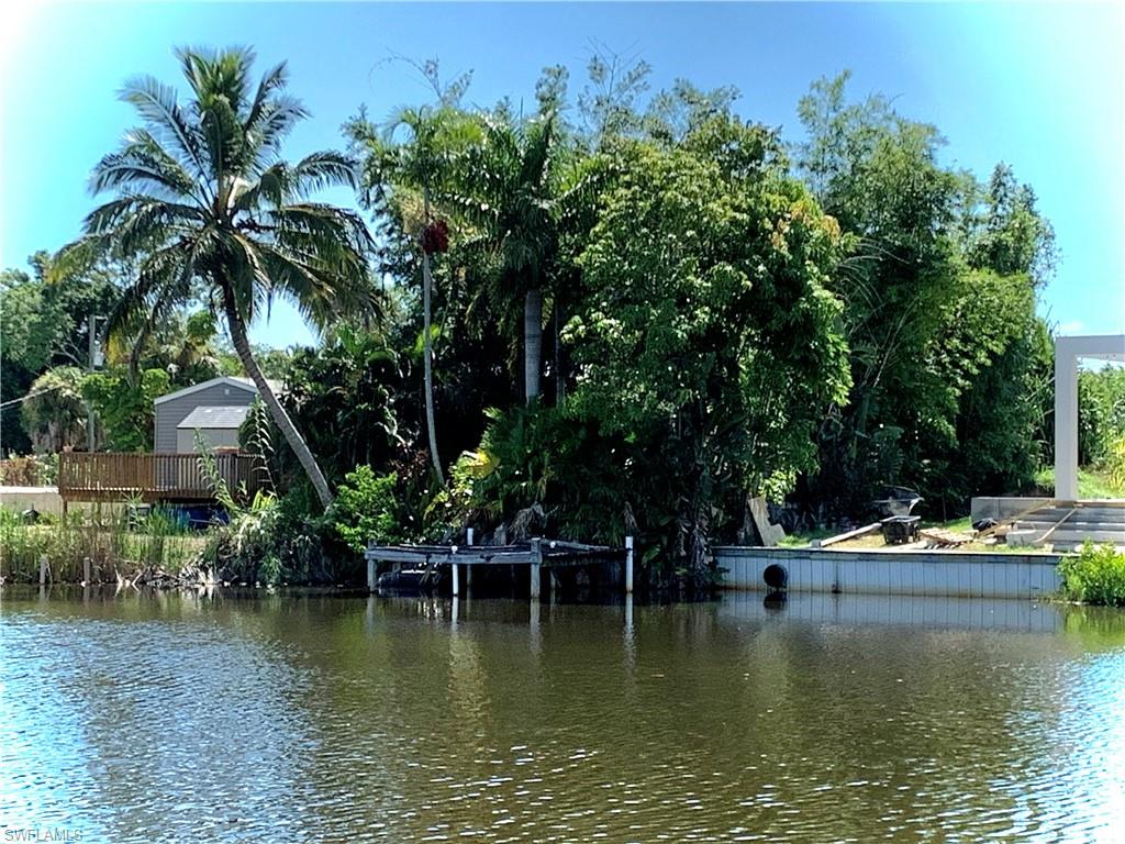4084 New Moon Court Naples, FL 34112 - Photo 6 of 22 a view of house with swimming pool and trees in the background