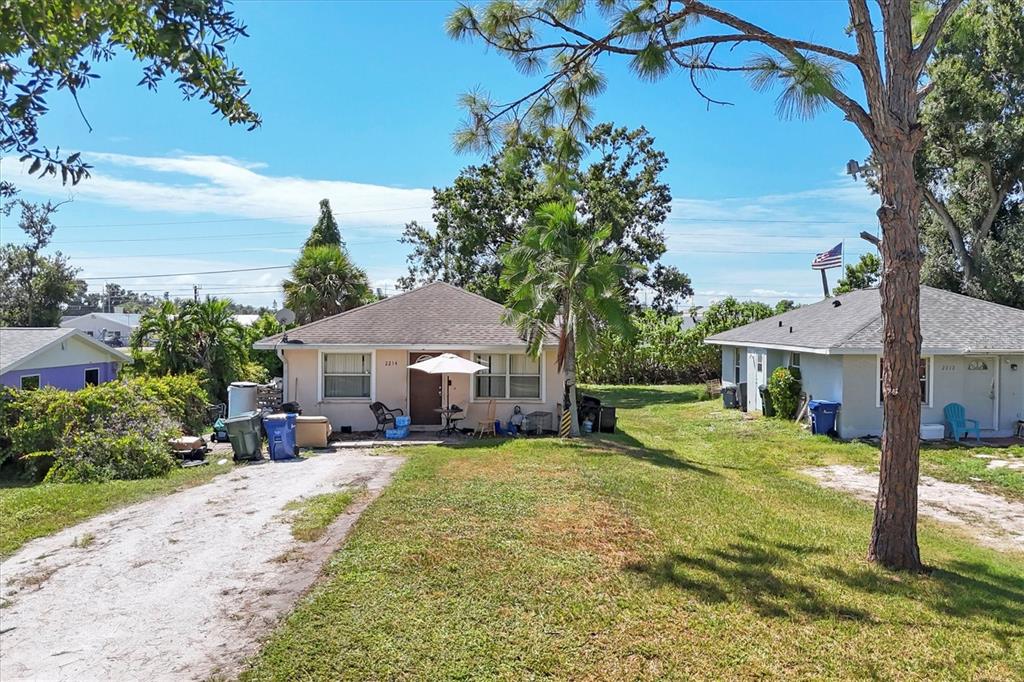 2214 Park Road Venice, FL 34293 - Photo 3 of 10 a view of a house with a yard and tree s