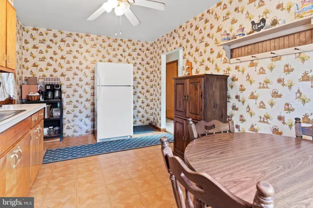 a dining room with wooden floor and chandelier