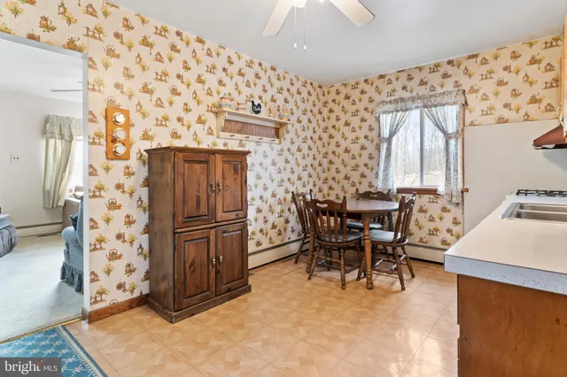a view of a dining room with furniture and a chandelier