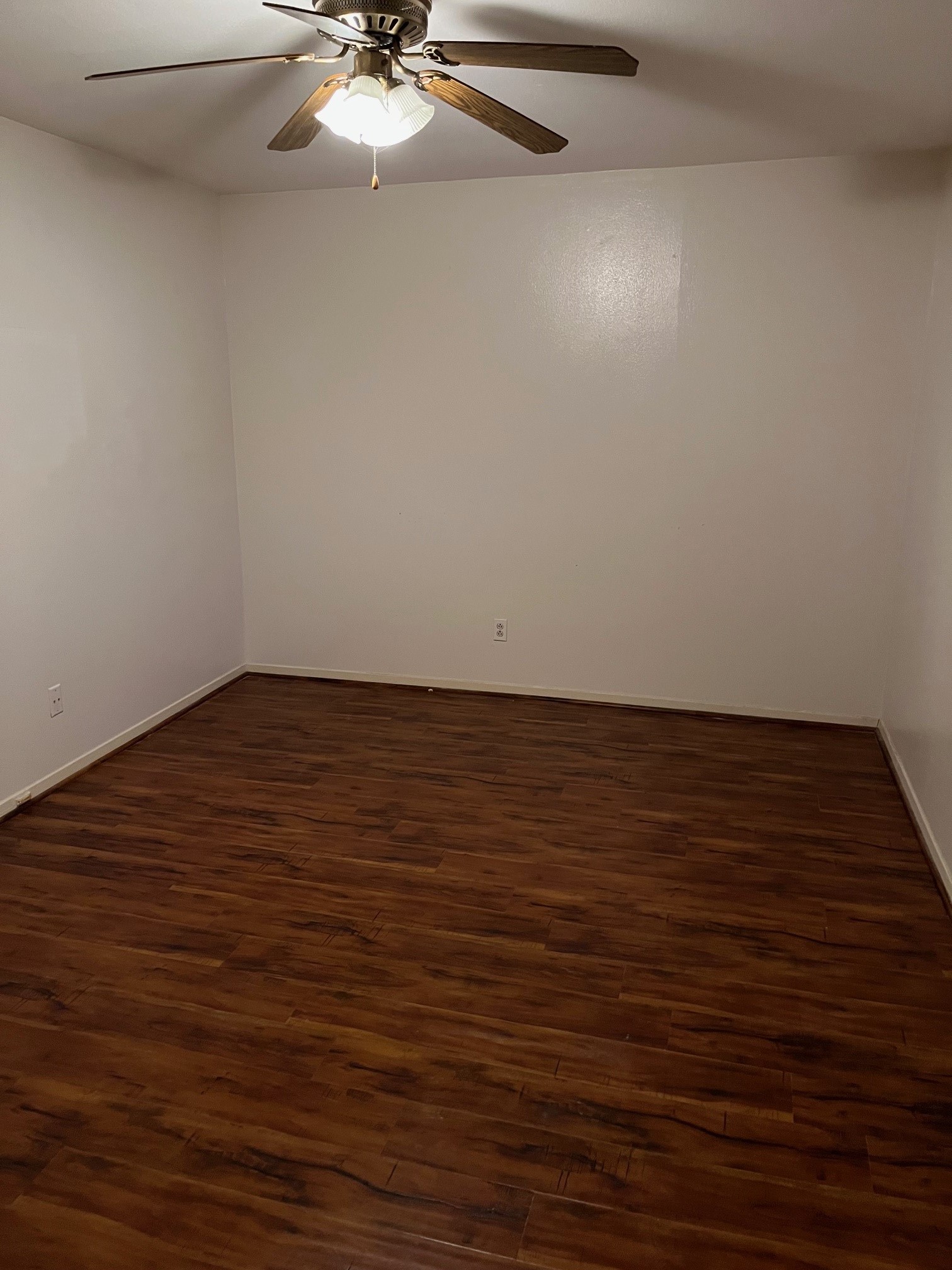 3938 West Alabama Street, Unit 12 Houston, TX 77027 - Photo 22 of 25 Spacious bedroom featuring ceiling fan, neutral paint & wood-look flooring.