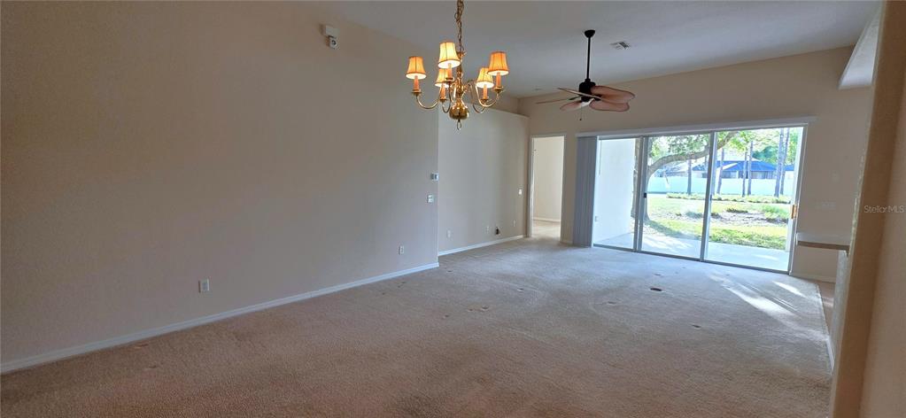 10906 Tree Cactus Loop Land O Lakes, FL 34638 - Photo 11 of 62 a view of a chandelier in a room with a chandelier