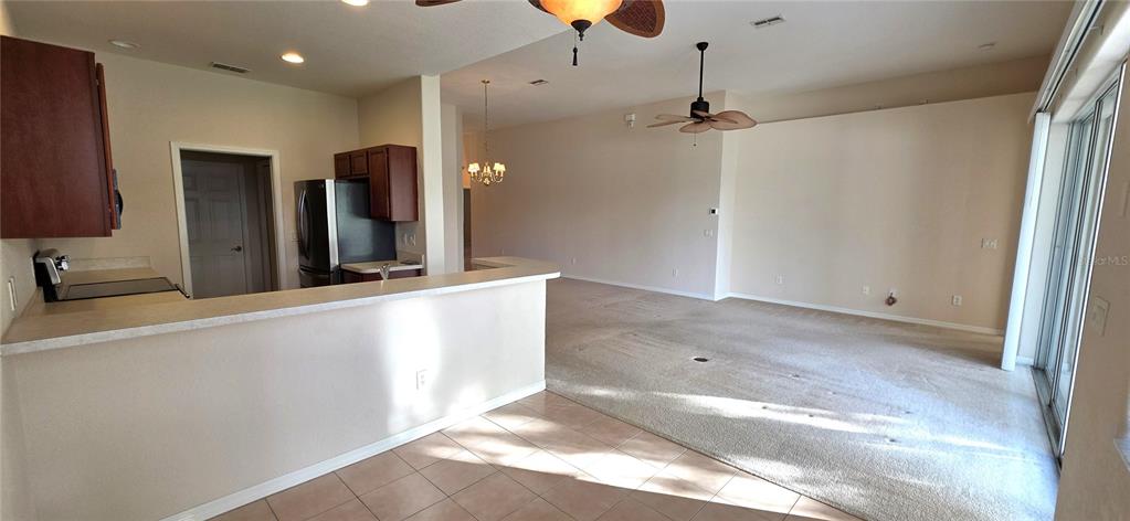 10906 Tree Cactus Loop Land O Lakes, FL 34638 - Photo 13 of 62 a view of a kitchen with a sink and a refrigerator