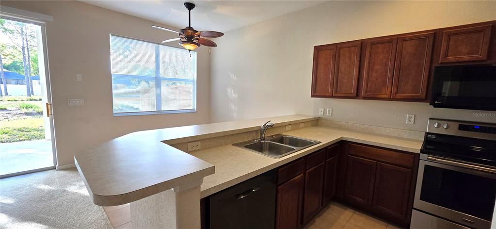 10906 Tree Cactus Loop Land O Lakes, FL 34638 - Photo 21 of 62 a kitchen with a sink cabinets and window
