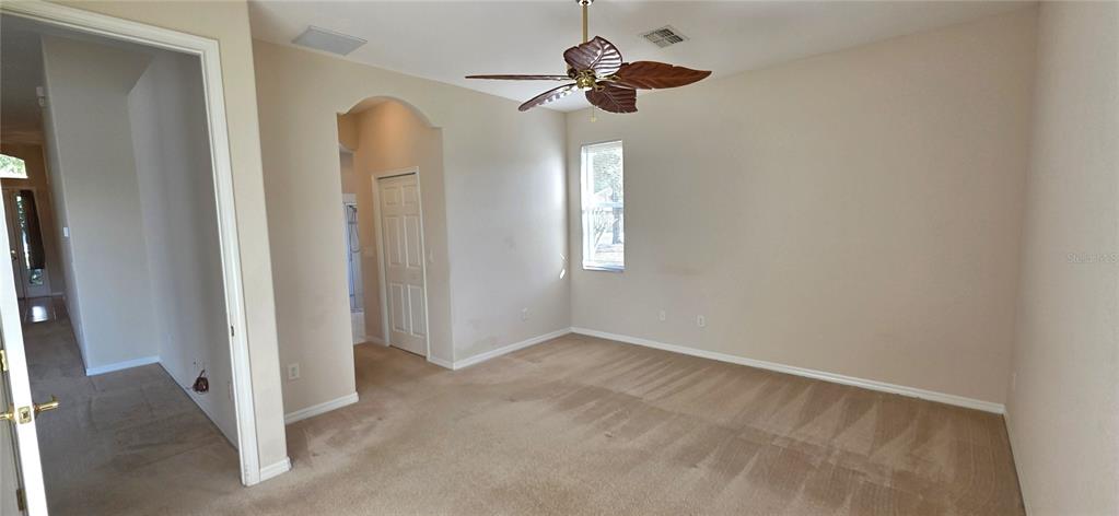 10906 Tree Cactus Loop Land O Lakes, FL 34638 - Photo 27 of 62 an empty room with windows and fan