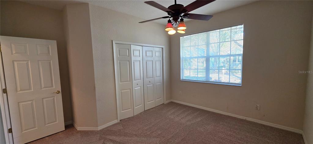 10906 Tree Cactus Loop Land O Lakes, FL 34638 - Photo 39 of 62 an empty room with windows and fan