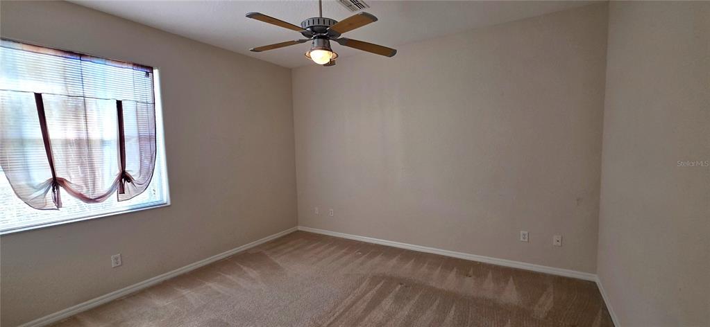 10906 Tree Cactus Loop Land O Lakes, FL 34638 - Photo 41 of 62 an empty room with a window and a fan