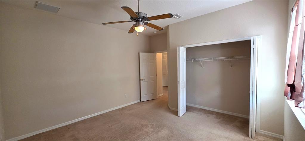 10906 Tree Cactus Loop Land O Lakes, FL 34638 - Photo 43 of 62 an empty room with a ceiling fan and a window