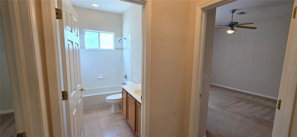 10906 Tree Cactus Loop Land O Lakes, FL 34638 - Photo 47 of 62 a view of a bathroom from a hallway