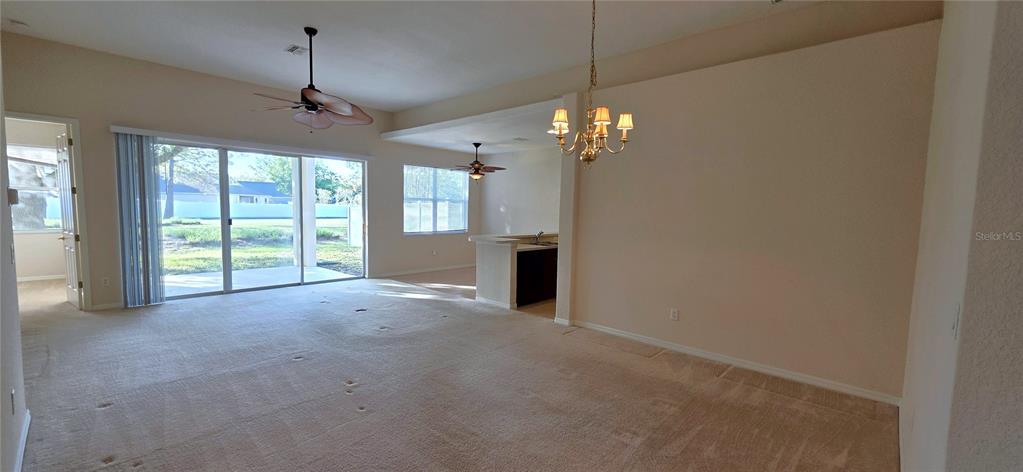 10906 Tree Cactus Loop Land O Lakes, FL 34638 - Photo 9 of 62 a view of a livingroom with a chandelier fan and windows