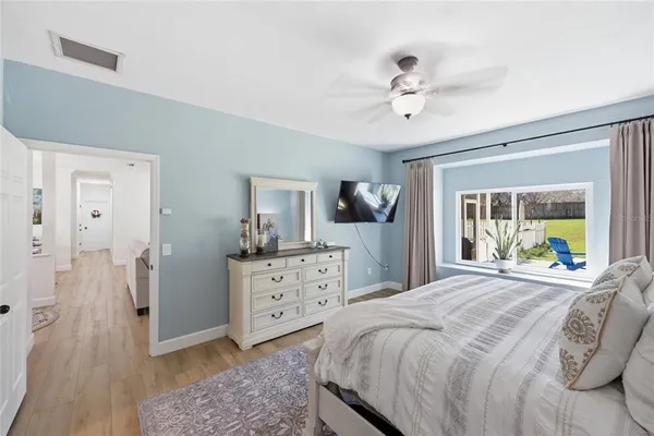 a bedroom with a bed a chandelier and a couch