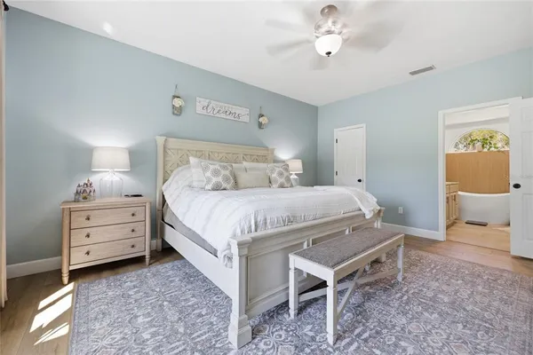 a bedroom with a bed cabinet and window