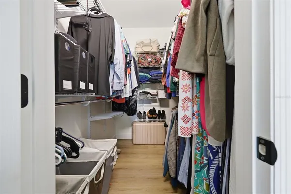 a spacious bedroom with a bed and a window