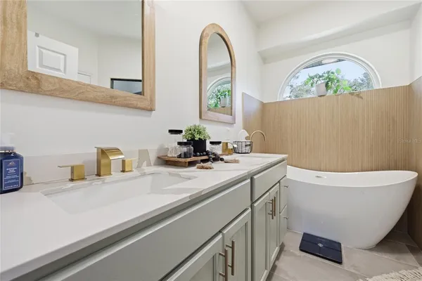 a living room with furniture a window and a flat screen tv