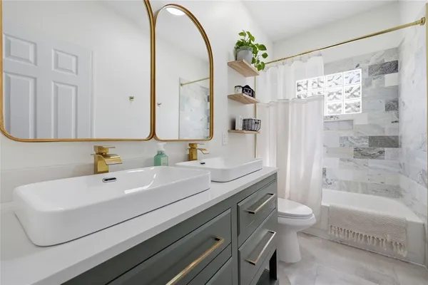 a bathroom with a sink a toilet and a mirror