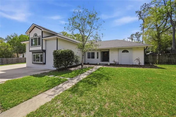 a living room with furniture a flat screen tv and a large window