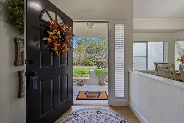 a view of a dining room with furniture wooden floor and chandelier
