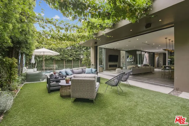a view of a patio with couches chairs and a potted plant