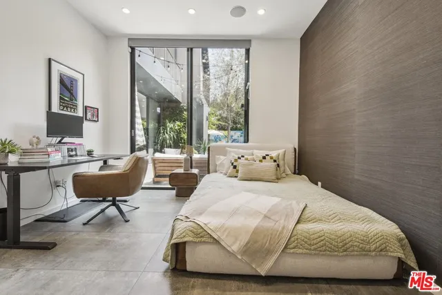 a bedroom with bed chair and window