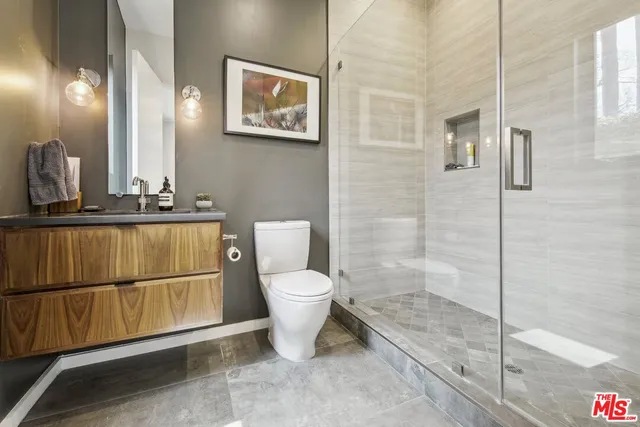 a bathroom with a toilet sink and shower