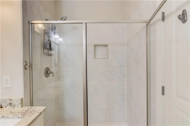 a bathroom with a shower and a sink