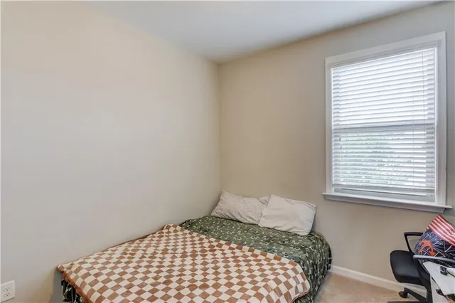 a bedroom with a bed and chair