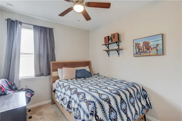 a bedroom with a large bed and a chandelier