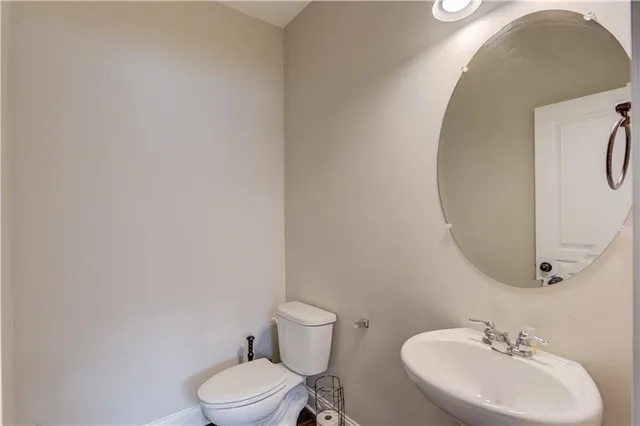 a bathroom with a sink mirror and toilet