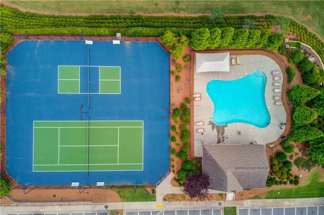 an aerial view of a house with a yard and lake view