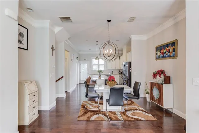 a view of a dining room with furniture wooden floor and chandelier