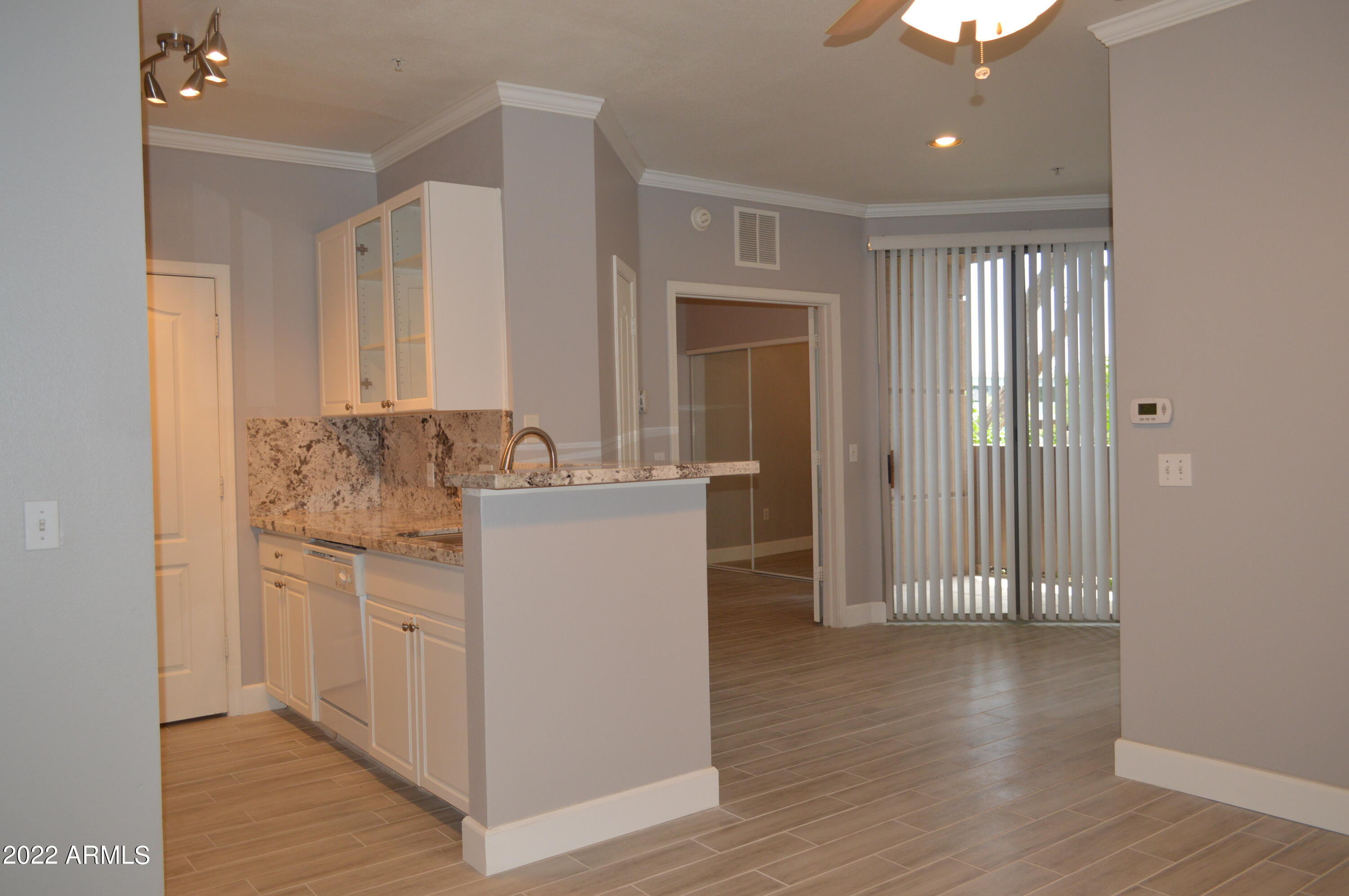 a room with white cabinets and sink
