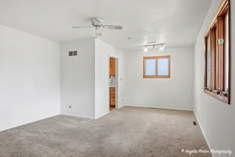 an empty room with windows and closet