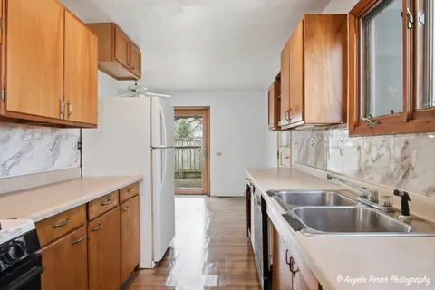 a kitchen with a sink cabinets and window