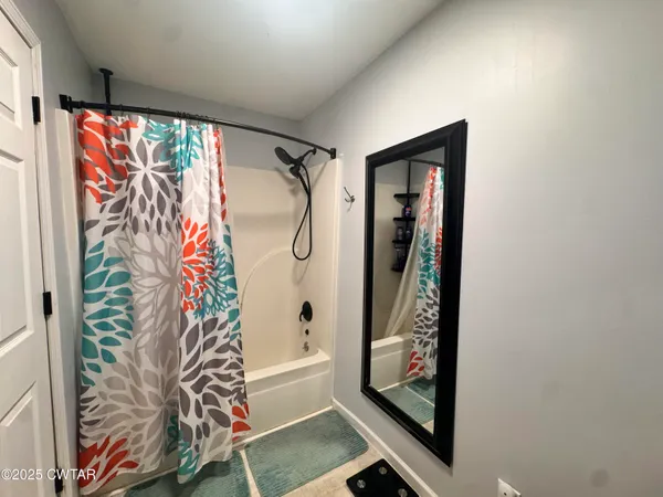 a bathroom with a large window and a shower