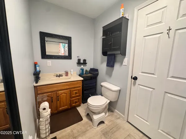a bathroom with a toilet a sink and a mirror